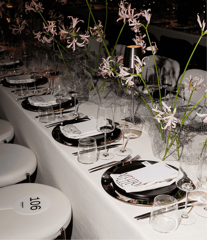 Cosmoscow dinner table with flowers and menus