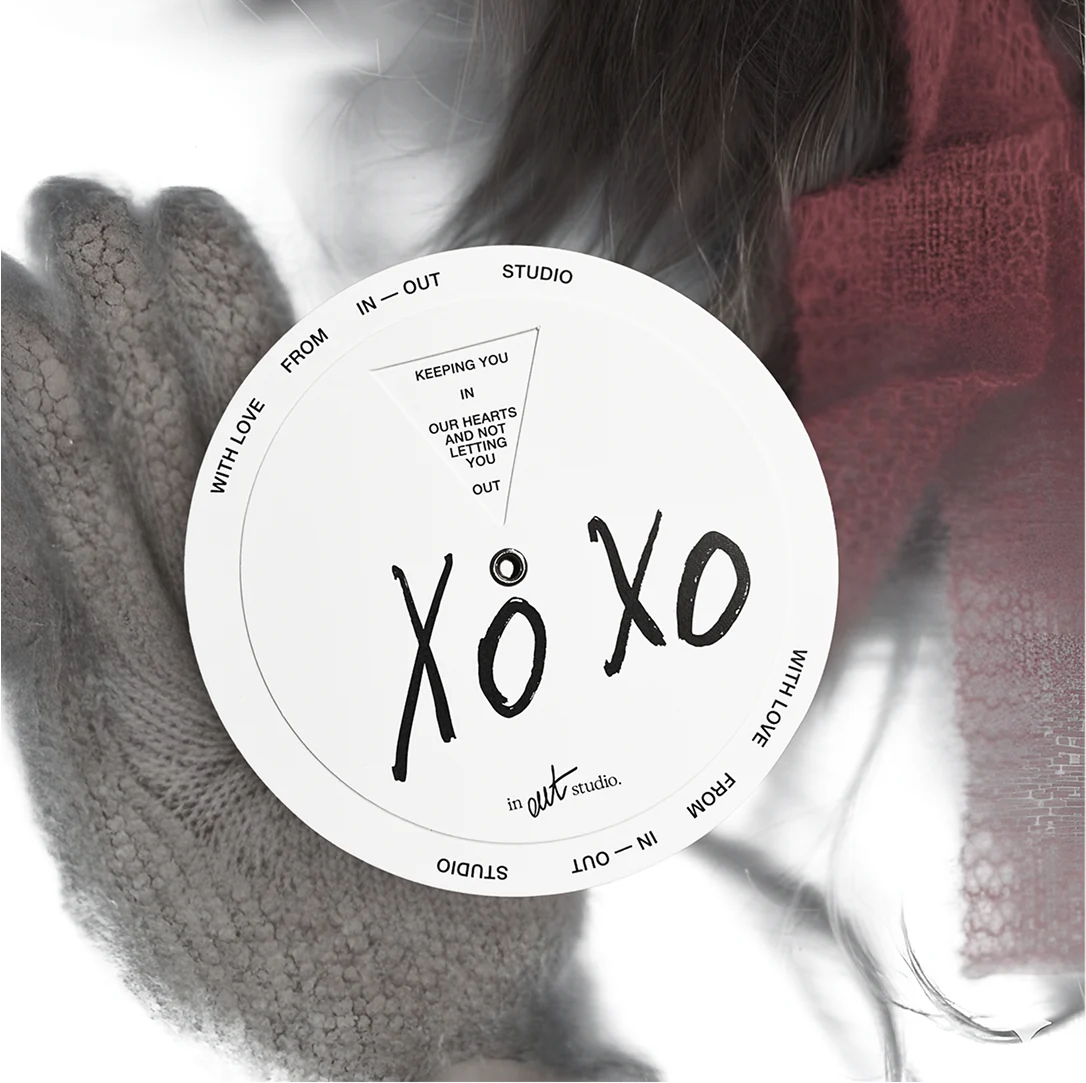 Round IN–OUT Studio XOXO sticker on a portrait