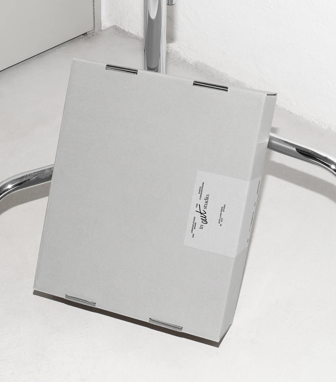 IN–OUT Studio branded cardboard box