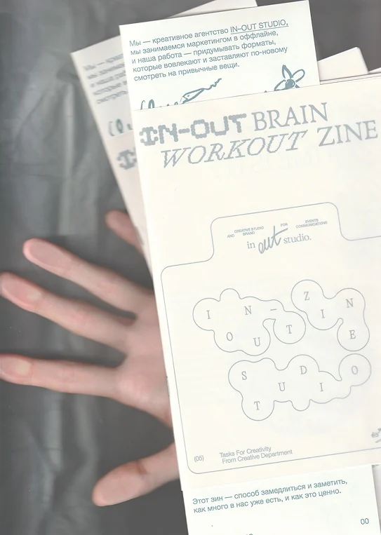 Hand holding zine copies