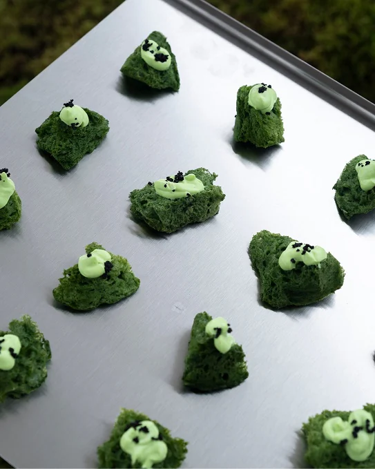 Green canapés on a steel tray