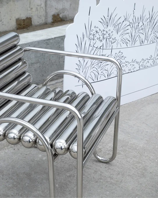 Chrome tube chair by a drawn screen