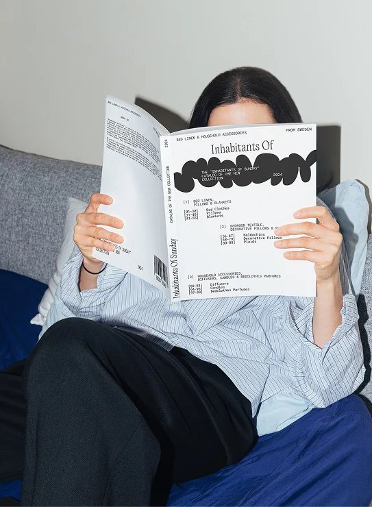 Woman reading the Inhabitants of Sunday catalogue